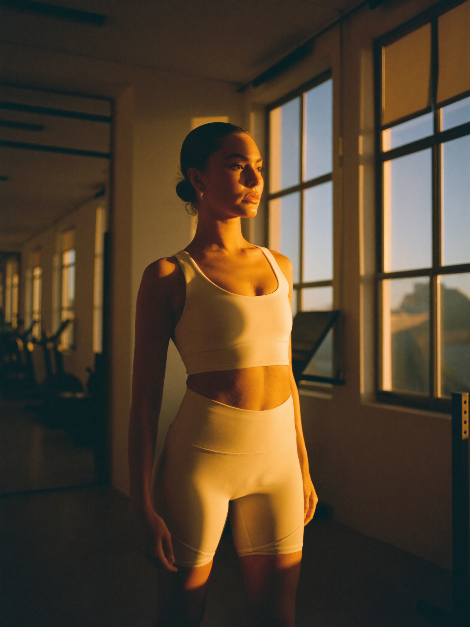 An athlete standing in first light in a quiet gym